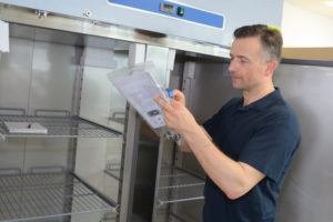 engineer servicing commercial refrigerator